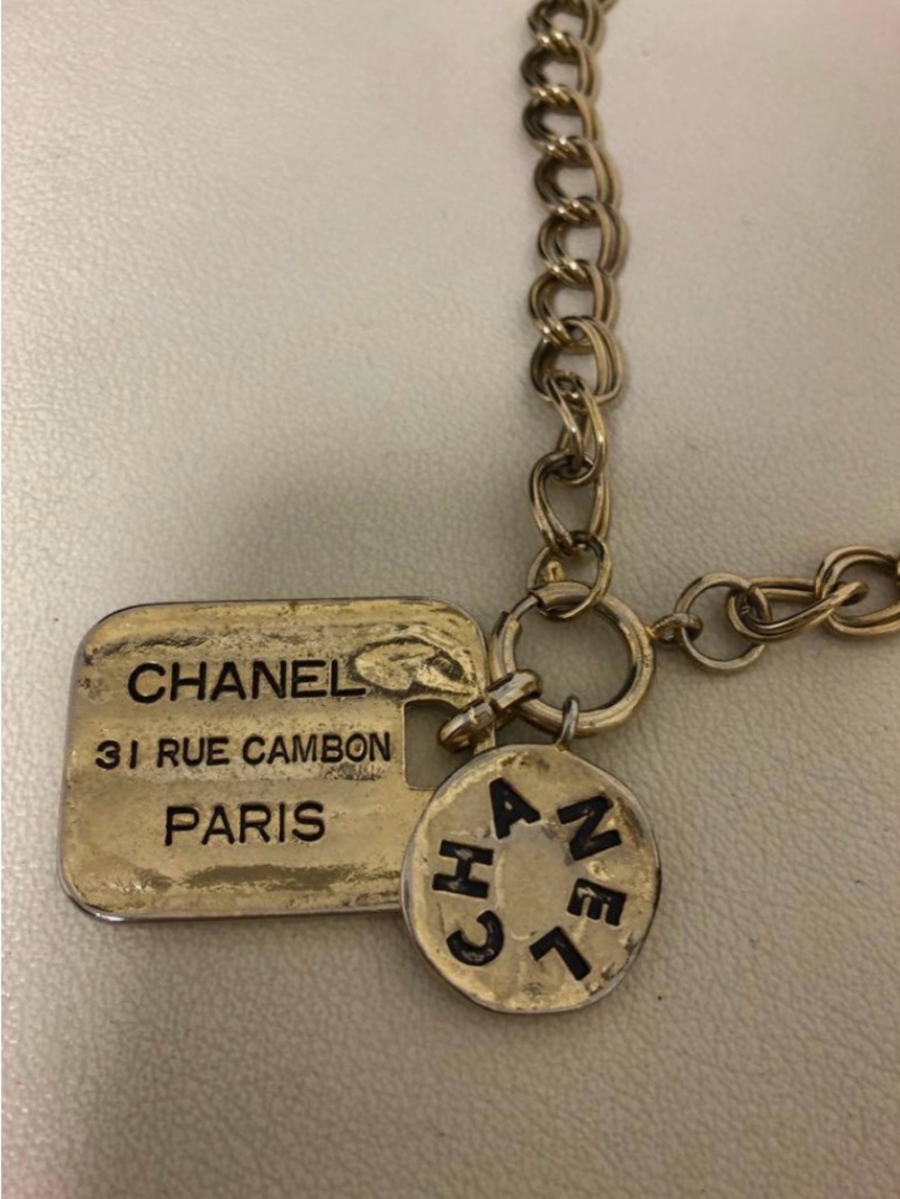 CHANEL Gold Tone Charm Necklace with Rue Cambon and Round Logo Tags